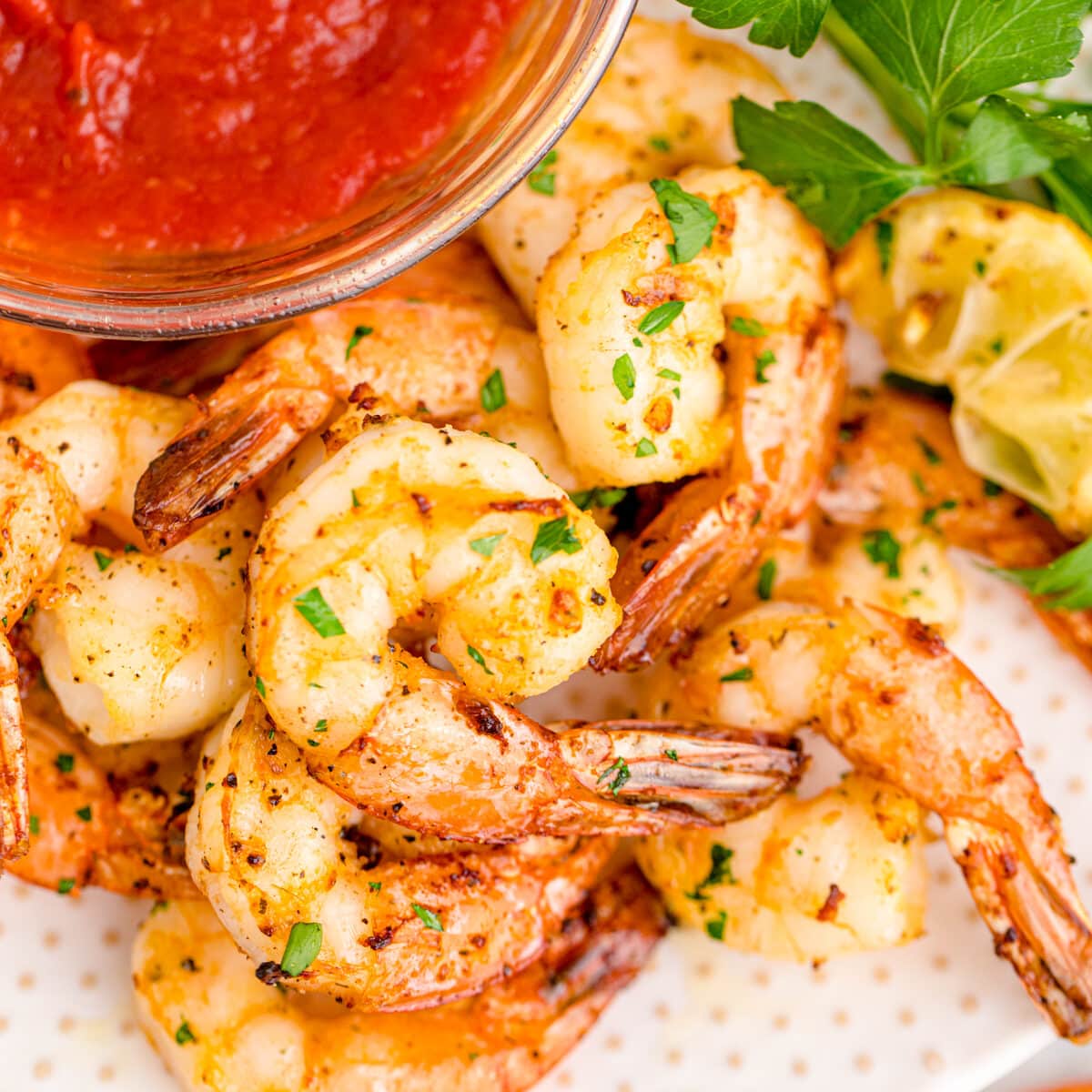 Air fried shrimp on a platter with cocktail sauce.